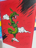 Angled front view of custom hand-painted Rayquaza VaultX binder — green Rayquaza soaring through white clouds on bold red background, freehand acrylic artwork by 5/14 Apparel