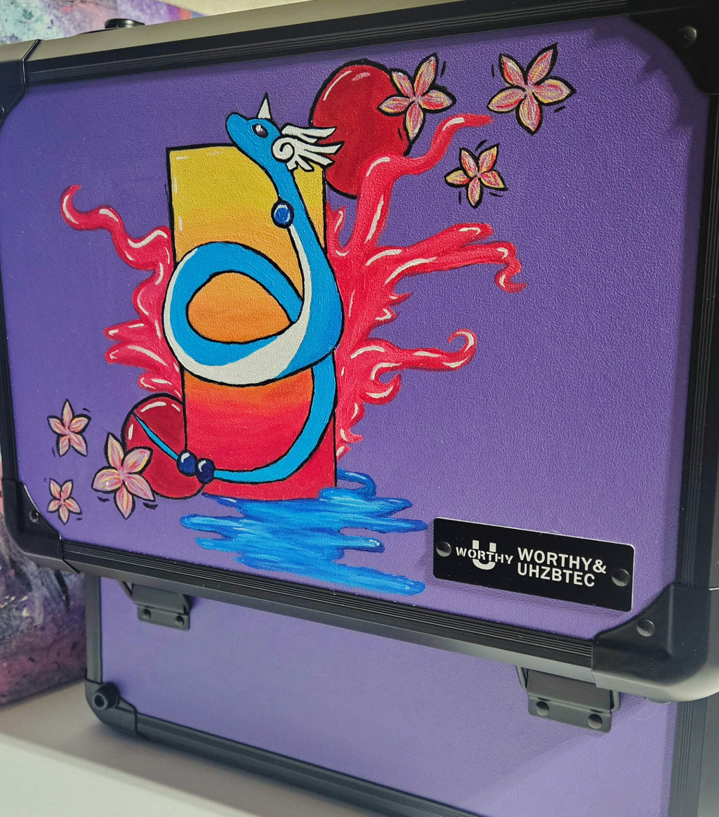 Side view of custom hand-painted Dragonair 3-row slab case — blue Dragonair coiled around a red and orange orb with cherry blossoms and red energy flames on purple background, freehand acrylic artwork by 5/14 Apparel