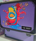 Side view of custom hand-painted Dragonair 3-row slab case — blue Dragonair coiled around a red and orange orb with cherry blossoms and red energy flames on purple background, freehand acrylic artwork by 5/14 Apparel