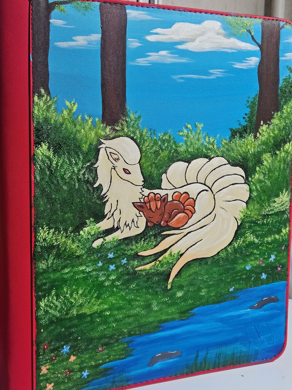 Side view of custom hand-painted Ninetales and Vulpix binder — one-of-a-kind freehand acrylic Pokemon card binder by 5/14 Apparel
