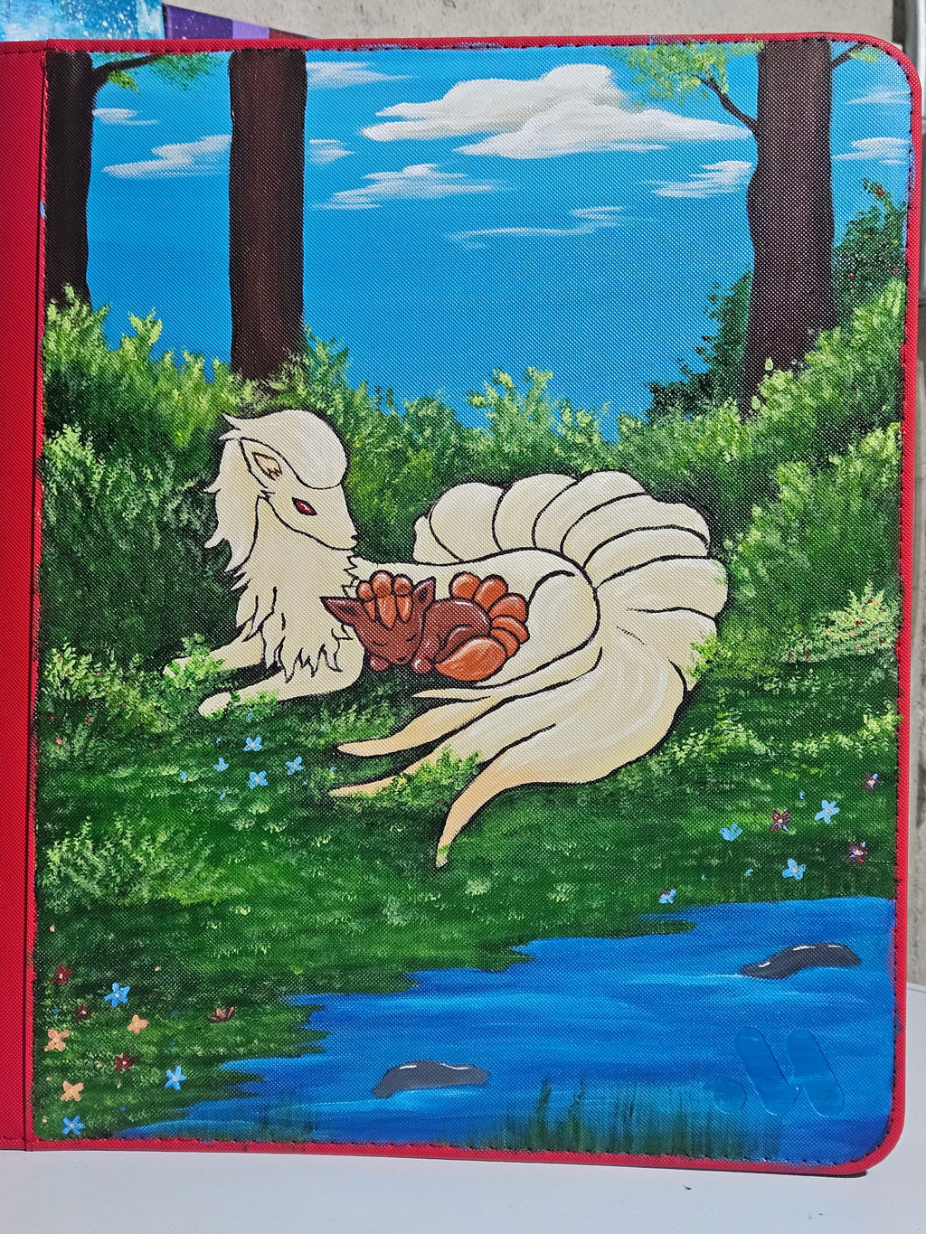 Front view of custom hand-painted Ninetales and Vulpix VaultX binder — freehand acrylic artwork featuring Ninetales and Vulpix, one-of-a-kind Pokemon card binder by 5/14 Apparel