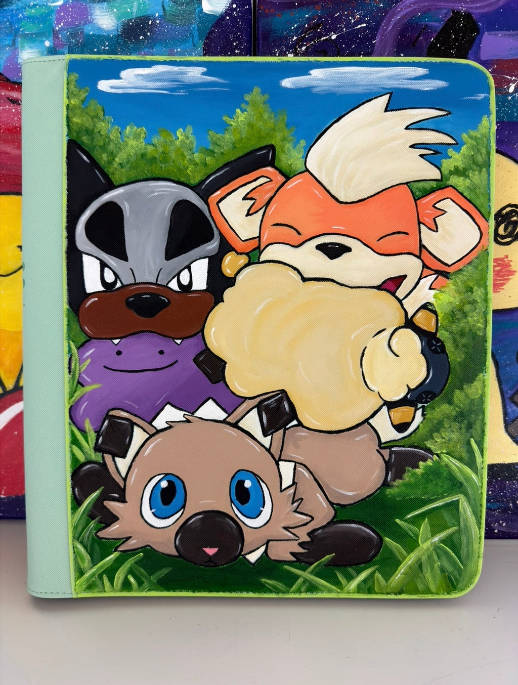 Front view of 5/14 Apparel Custom Rockruff Houndour and Growlithe hand-painted binder — Rockruff, Houndour, Growlithe, and Ditto/Mareep Toy in green meadow scene on lime green Ultrapro binder, one-of-one hand-painted Pokemon card binder