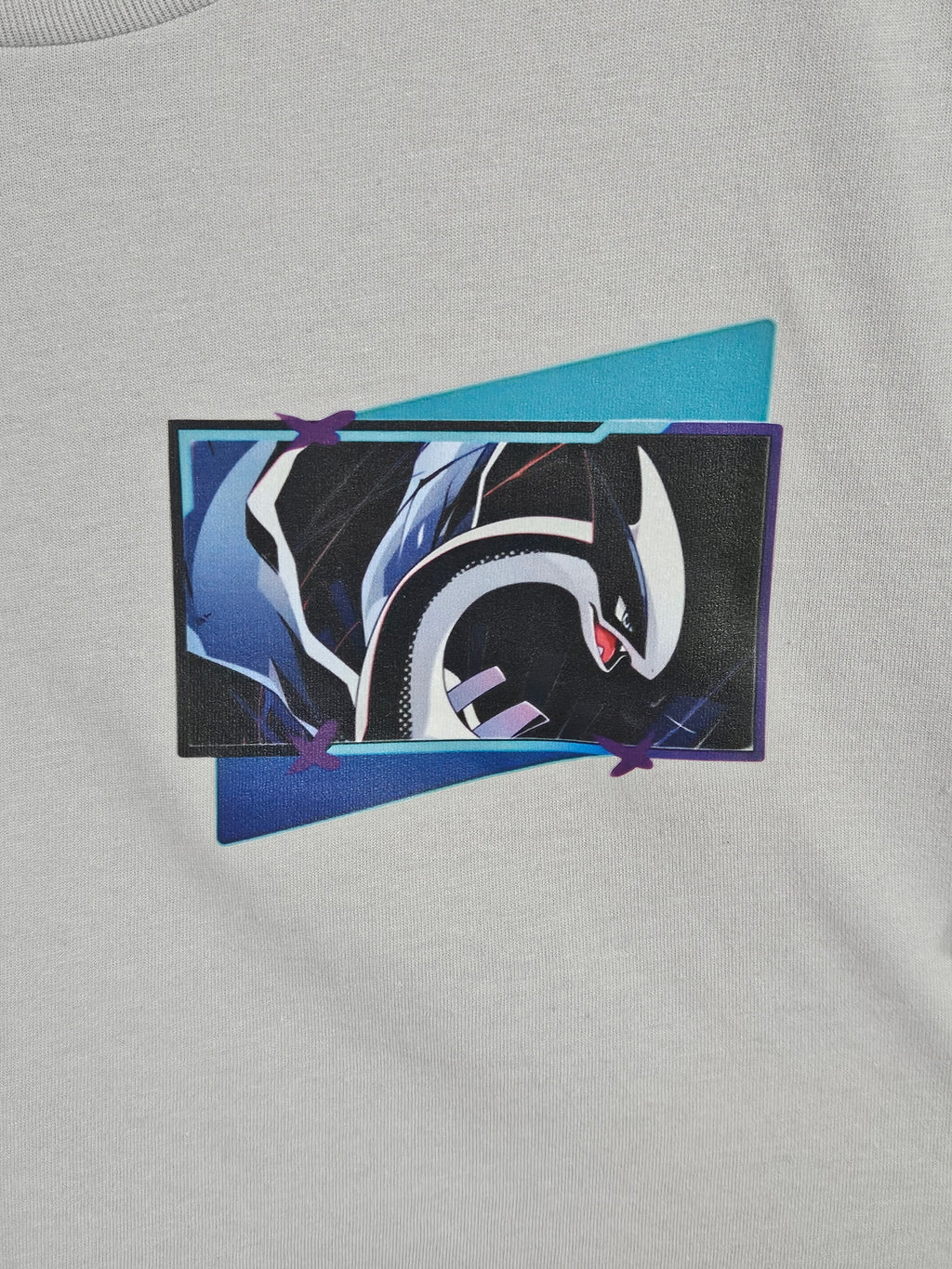 Close-up of Lugia panel graphic on gray tee — bold Lugia close-up in blue, teal, and purple frame design by 5/14 Apparel