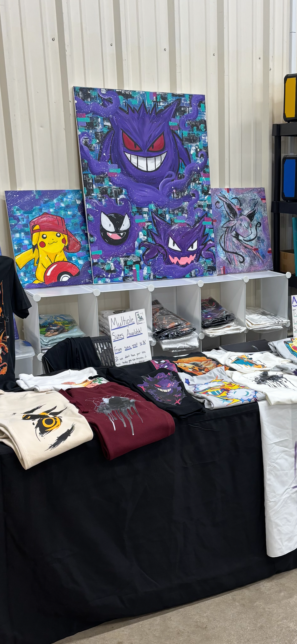 5/14 Apparel Gengar canvas art displayed at convention booth alongside Pikachu and Espeon canvases, original hand-painted Pokemon wall art by 5/14 Apparel