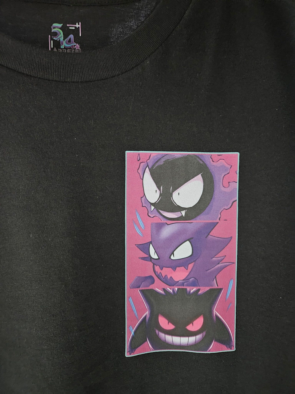 Close-up of Gastly, Haunter, and Gengar evolution panel graphic on black tee — three-panel pink and purple ghost-type design by 5/14 Apparel