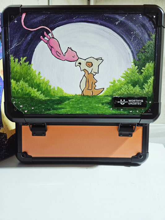Front view of custom hand-painted Cubone and Mew 3-row orange slab case — freehand acrylic artwork featuring Mew descending toward Cubone under a full moon
