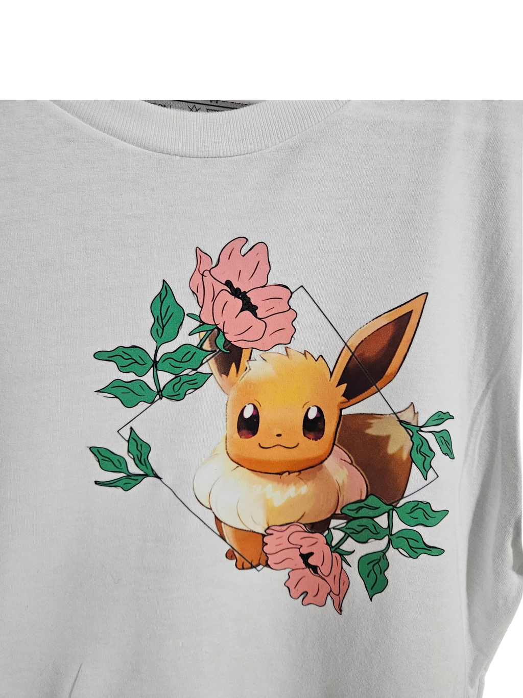 Close-up of Eevee floral graphic on white tee — Eevee surrounded by pink flowers and green leaves design by 5/14 Apparel