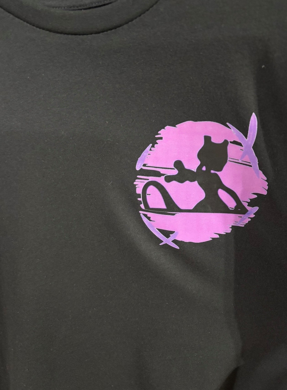 Close-up of Mewtwo chest graphic on black long sleeve — purple Mewtwo silhouette circle design by 5/14 Apparel