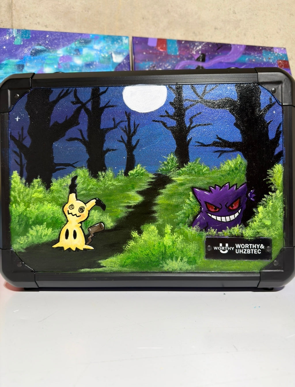 Front view of custom hand-painted Gengar and Mimikyu limited quantity 3-row slab case — Mimikyu and Gengar lurking in a moonlit dark forest on deep blue-purple background, freehand acrylic artwork by 5/14 Apparel
