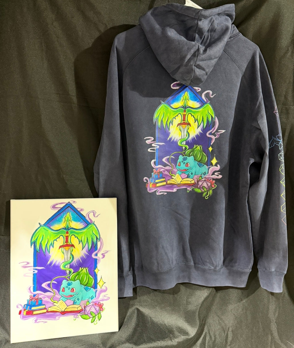 5/14 Apparel custom art and apparel package example — gray hoodie back with full Bulbasaur wizard DTF print matching hand-painted acrylic canvas, one-of-a-kind made to order