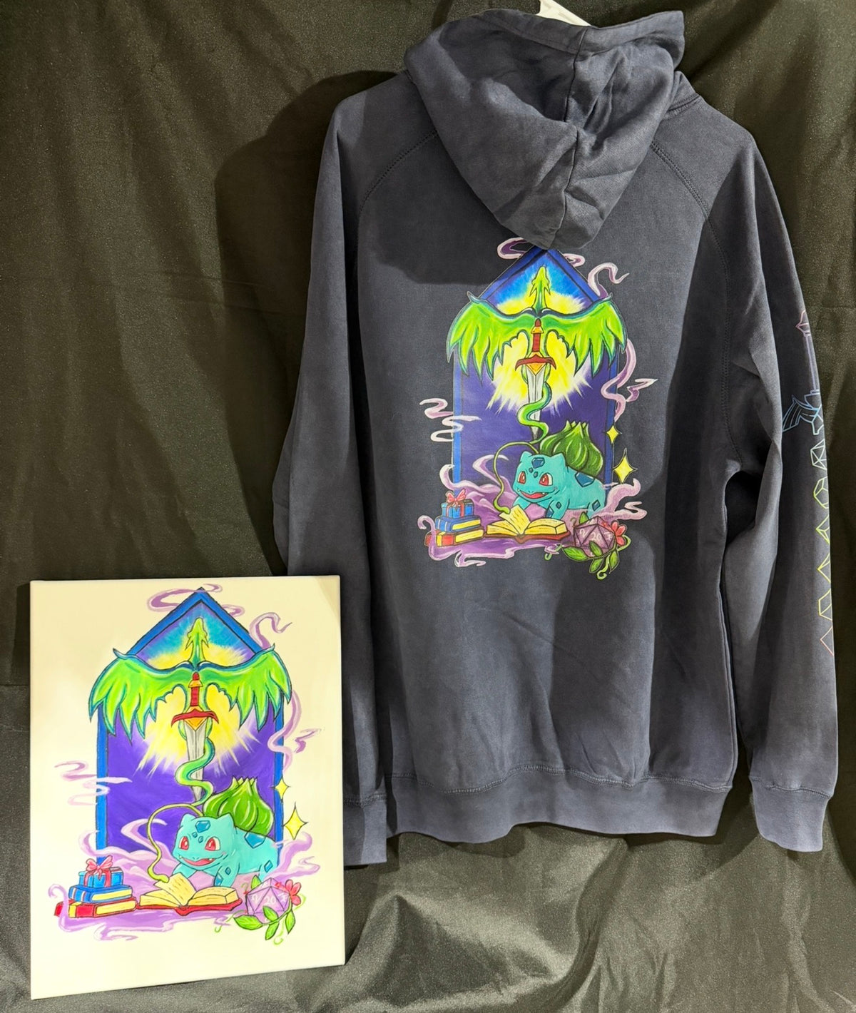 5/14 Apparel custom art and apparel package example — gray hoodie back with full Bulbasaur wizard DTF print matching hand-painted acrylic canvas, one-of-a-kind made to order