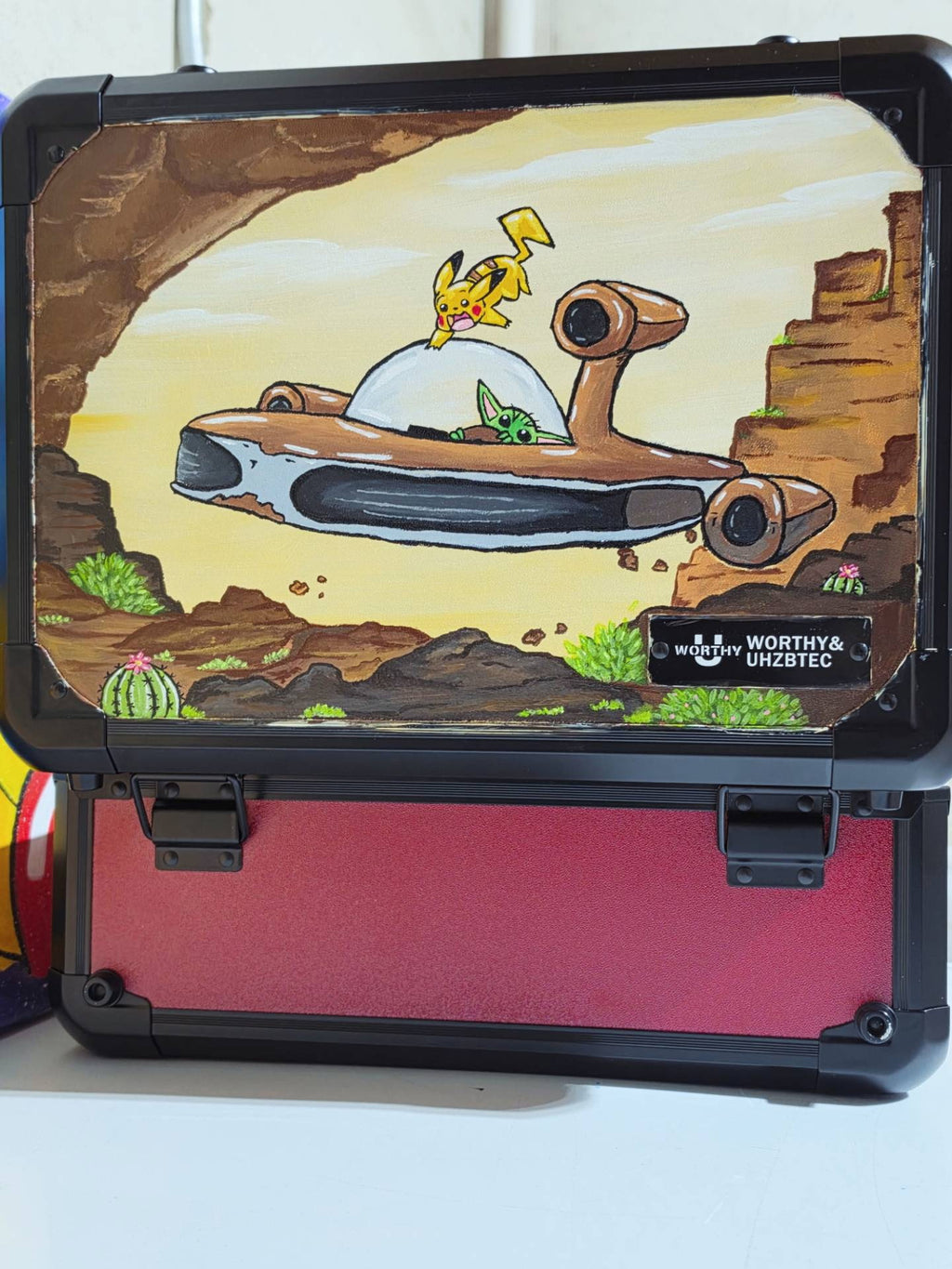 Hand-painted Gotta Catch Grogu slab case open view — Pikachu & Grogu Razor Crest artwork on lid, red interior, key latches, black 3-row case by 5/14 Apparel x Worthy & Uhzbtec