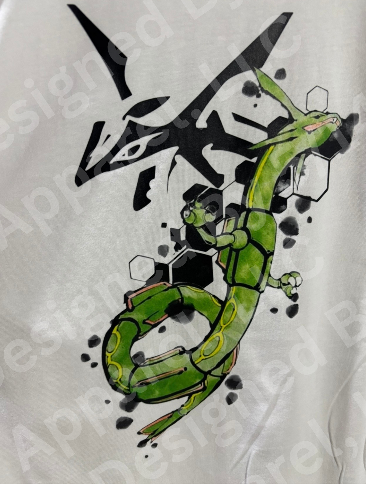 Close-up of Rayquaza watercolor graphic on white tee — Rayquaza in green watercolor with black geometric hexagon shapes design by 5/14 Apparel