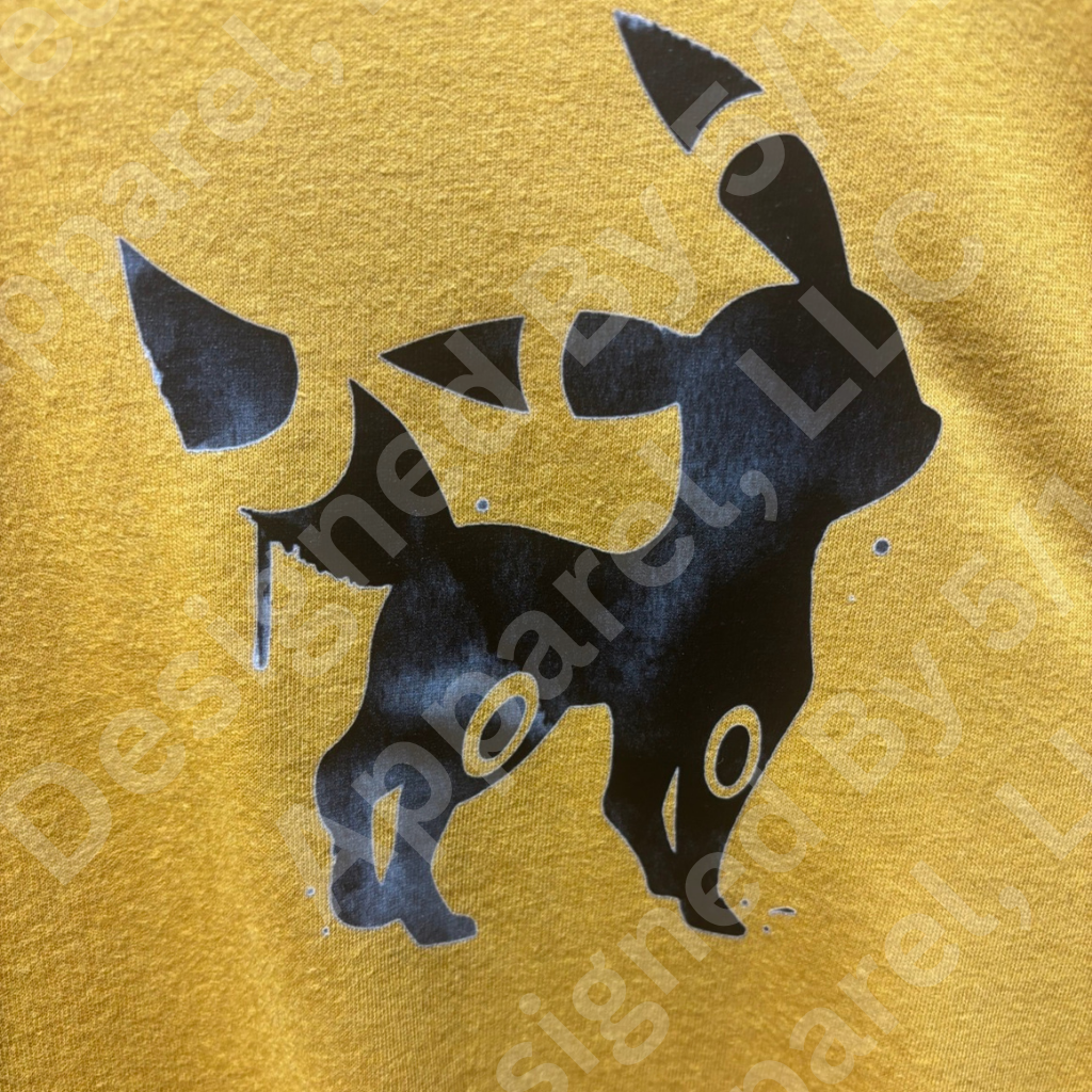 Close-up of Umbreon graphic on antique gold crop tee — original dark-type Pokemon silhouette design by 5/14 Apparel