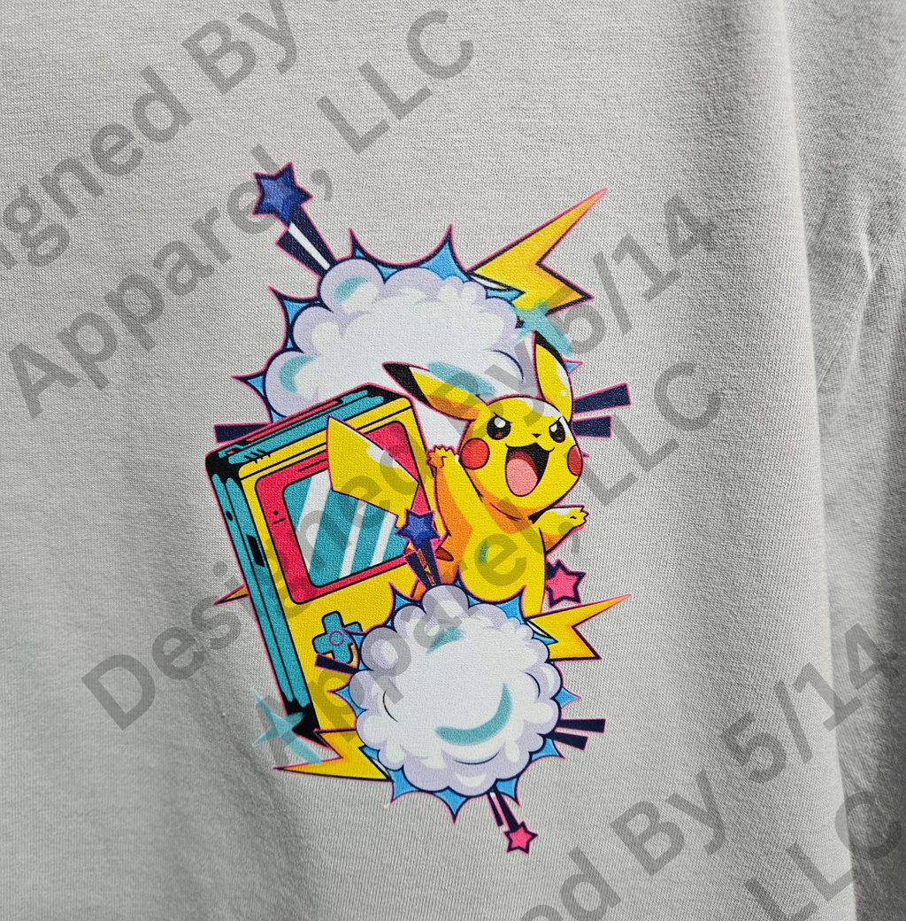 Close-up of Pikachu retro Game Boy graphic on white tee — Pikachu leaping from Game Boy with lightning and stars design by 5/14 Apparel